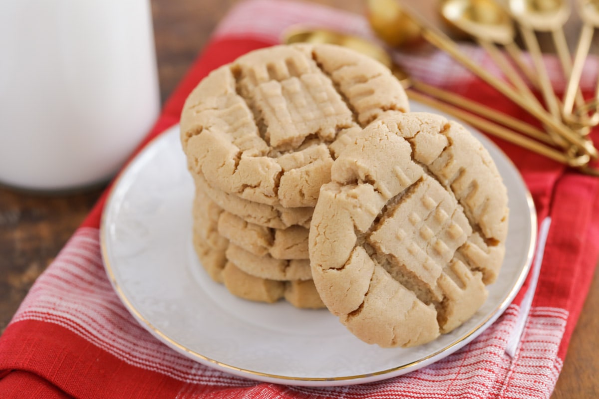 Peanut butter cookies stacked on a white plate