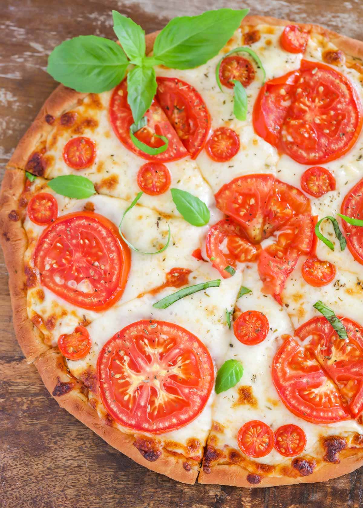Tomato pizza topped with fresh basil