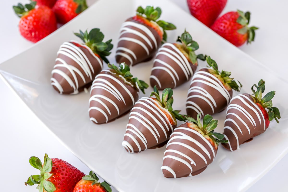 Chocolate Covered strawberries recipe topped with white chocolate drizzle.