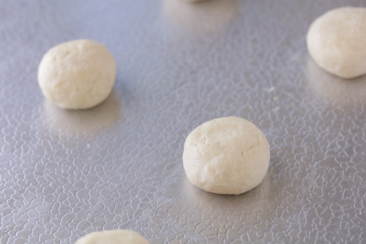 Cream cheese cookies rolled into balls and placed on cookie sheet