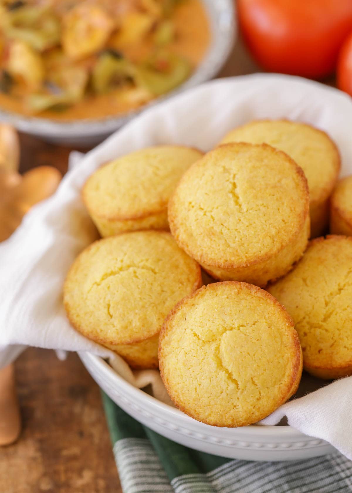 Honey cornbread muffins in a white bowl.