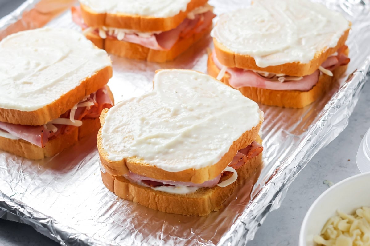 Making Croque Monsieur sandwich.