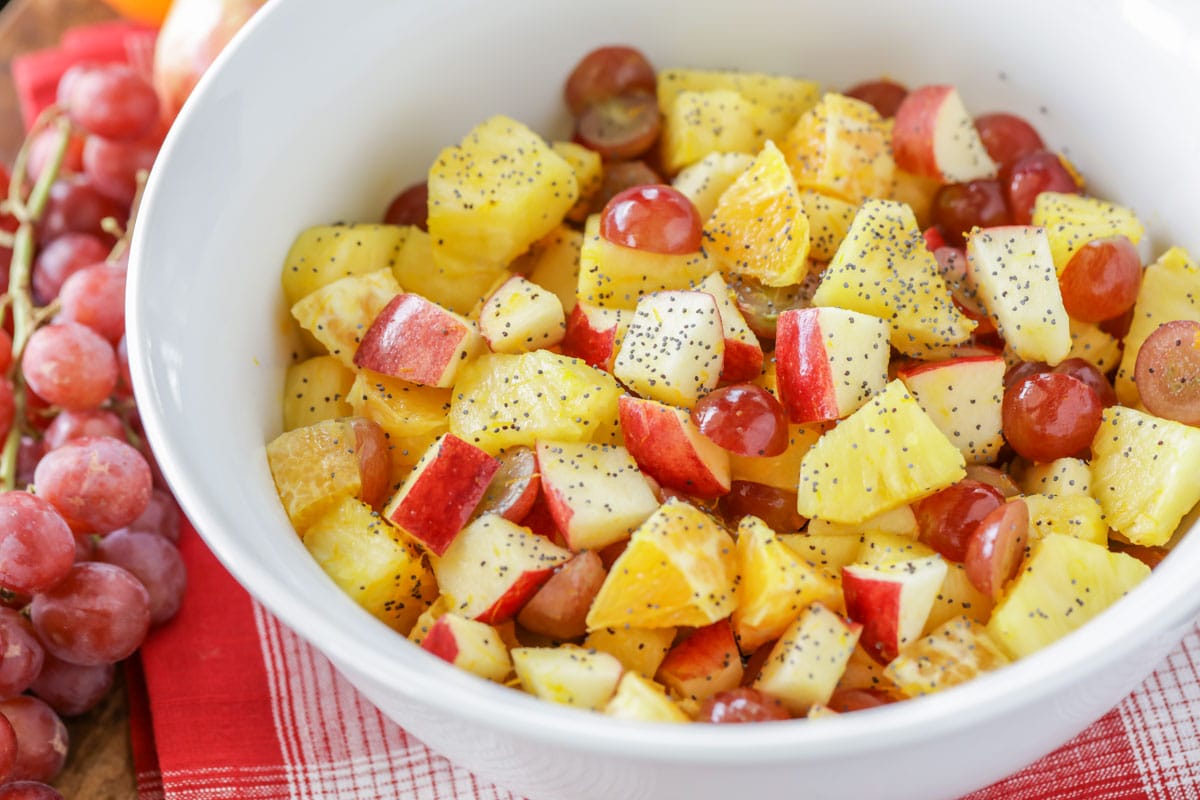 Fall fruit salad chopped and dressed in a white bowl.