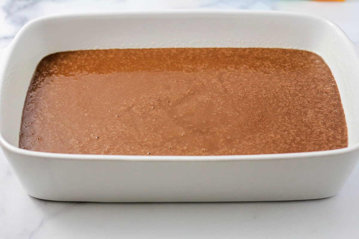Chocolate cake batter in a baking dish.