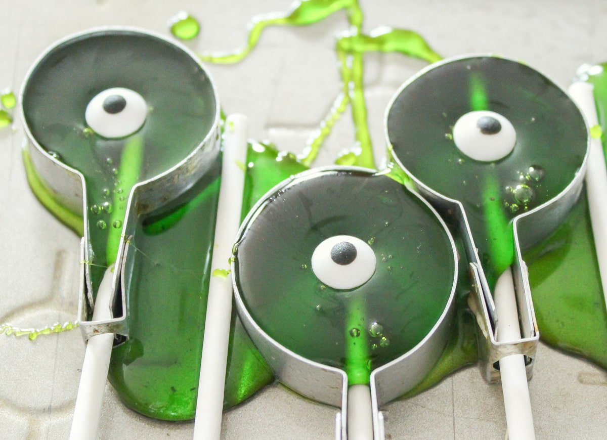 Green candy poured into sucker molds