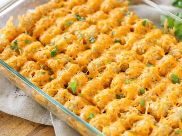 A casserole dish filled with hamburger tater tot casserole.