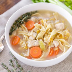 Chicken corn soup served in a white bowl.