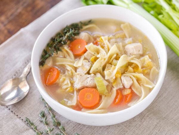 Chicken corn soup served in a white bowl.