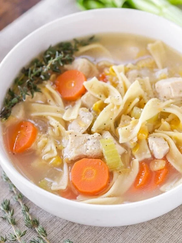Chicken corn soup served in a white bowl.