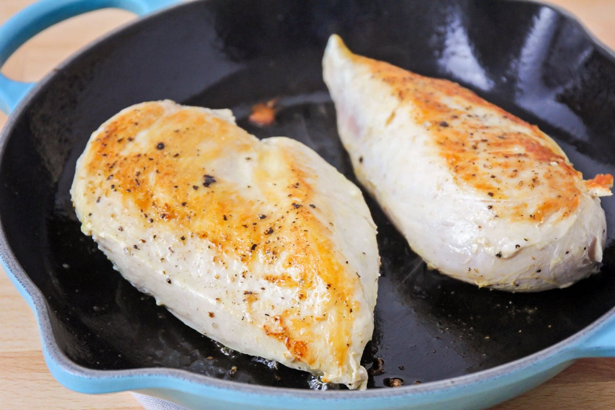 chicken browning in a pan