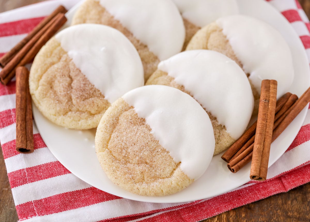 white chocolate dipped snickerdoodles on a white plate