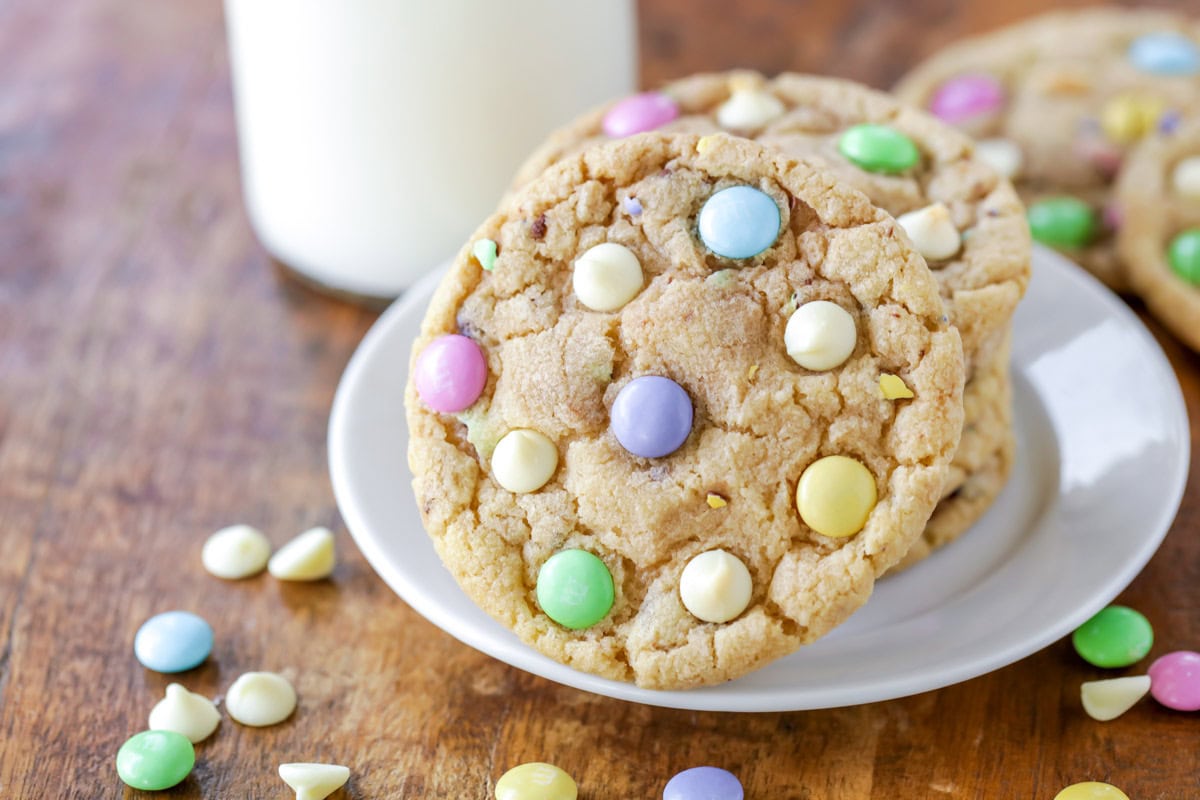 Easter cookies stacked on a plate and served with milk.