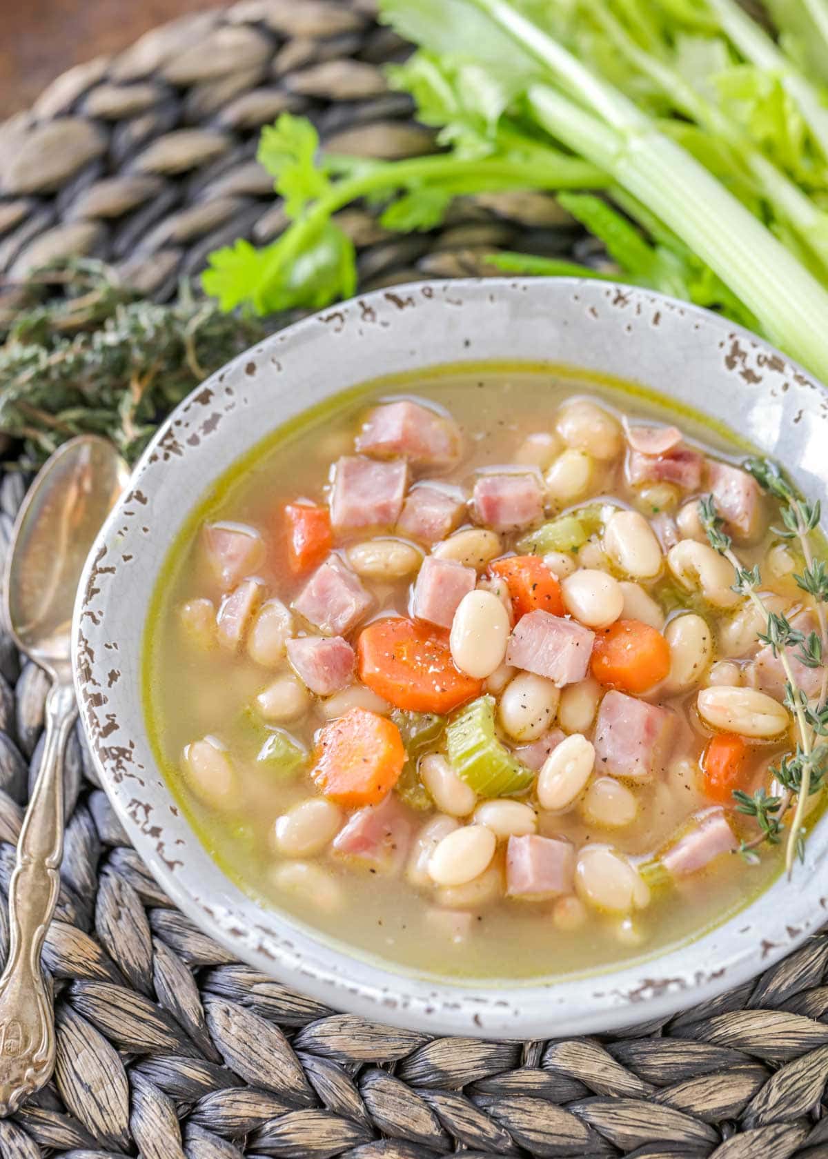Ham and bean soup in a rustic white bowl