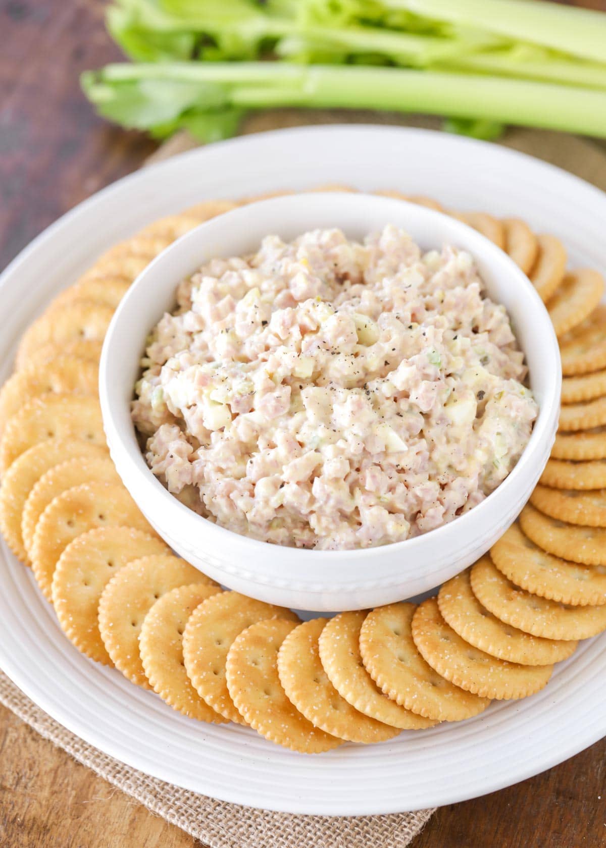 ham salad served in a white bowl with crackers
