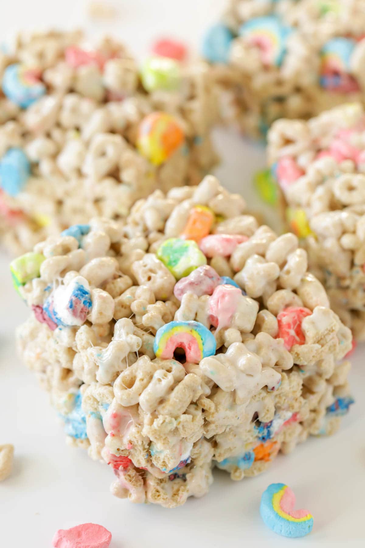 Lucky Charms Treats recipe cut and served on a counter.