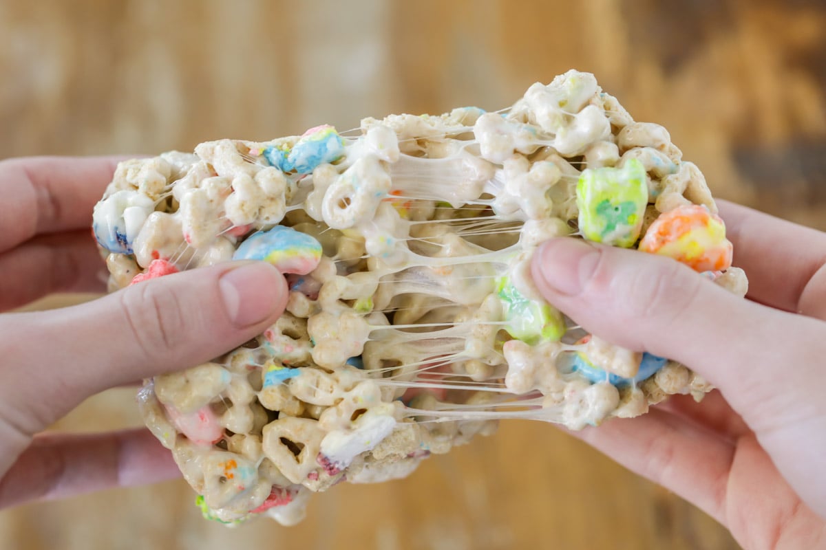 Gooey Lucky Charms treats recipe being pulled apart.