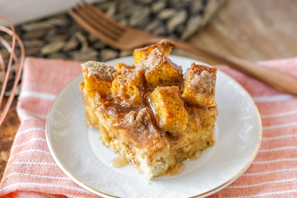 Breakfast for dinner - square of pumpkin french toast bake served on a white plate.