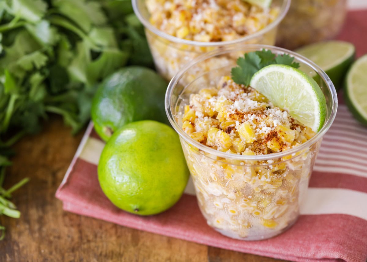 Close up image of esquites recipe poured into clear cups.