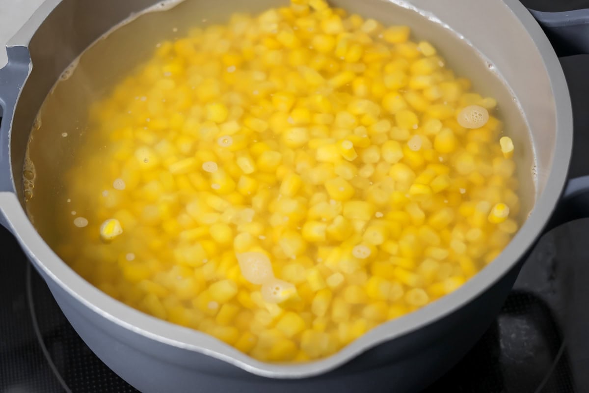 Corn being cooked in bowl.