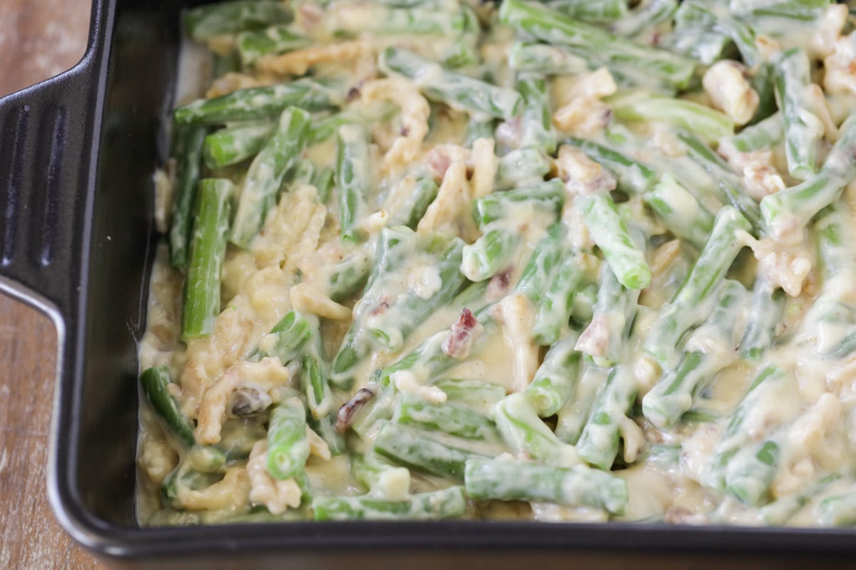 creamy green beans in a black baking dish