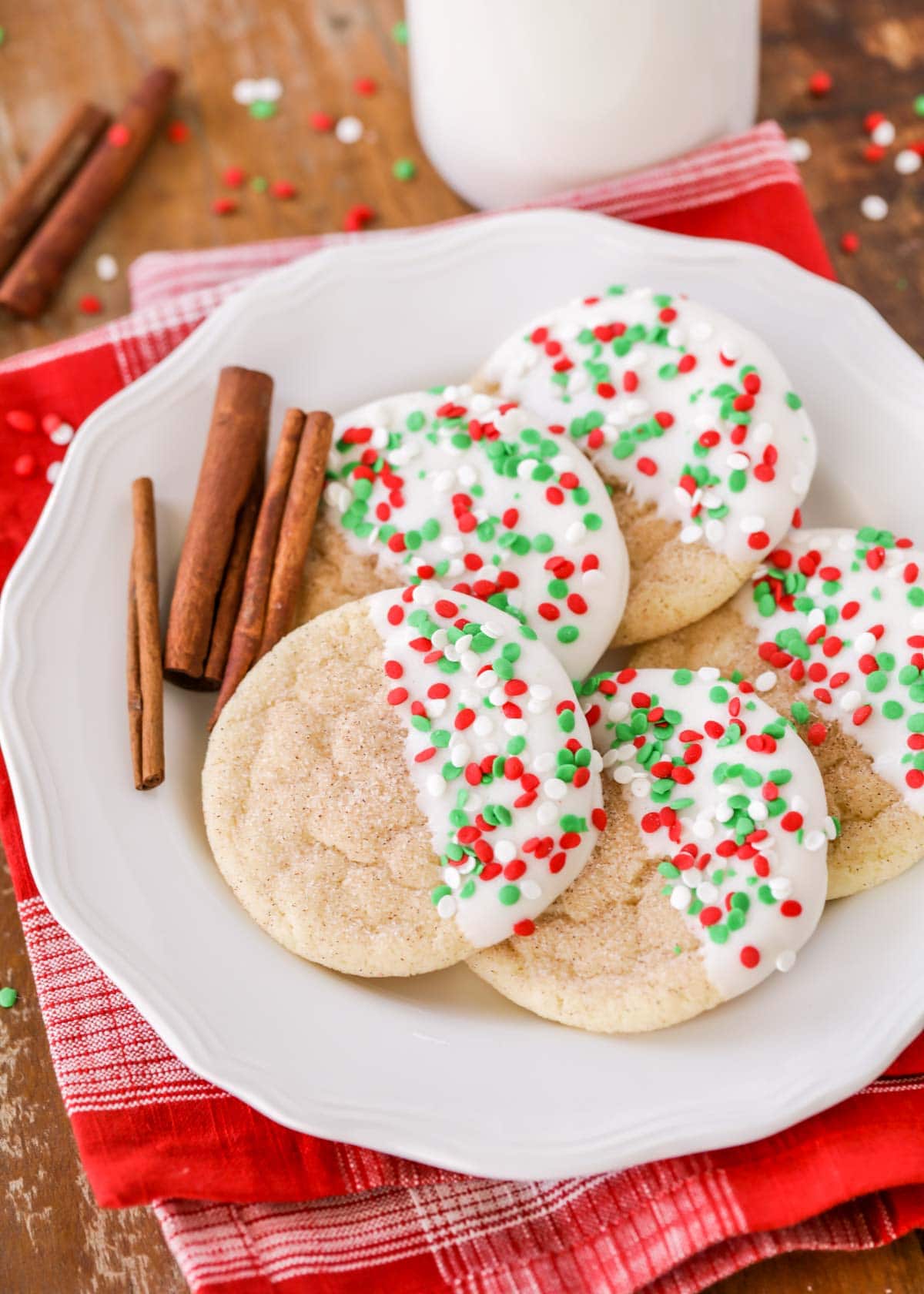 White chocolate dipped Christmas snickerdoodles on a white plate