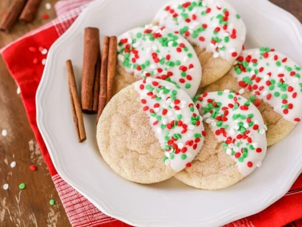 Christmas snickerdoodles dipped in white chocolate and topped with sprinkles.