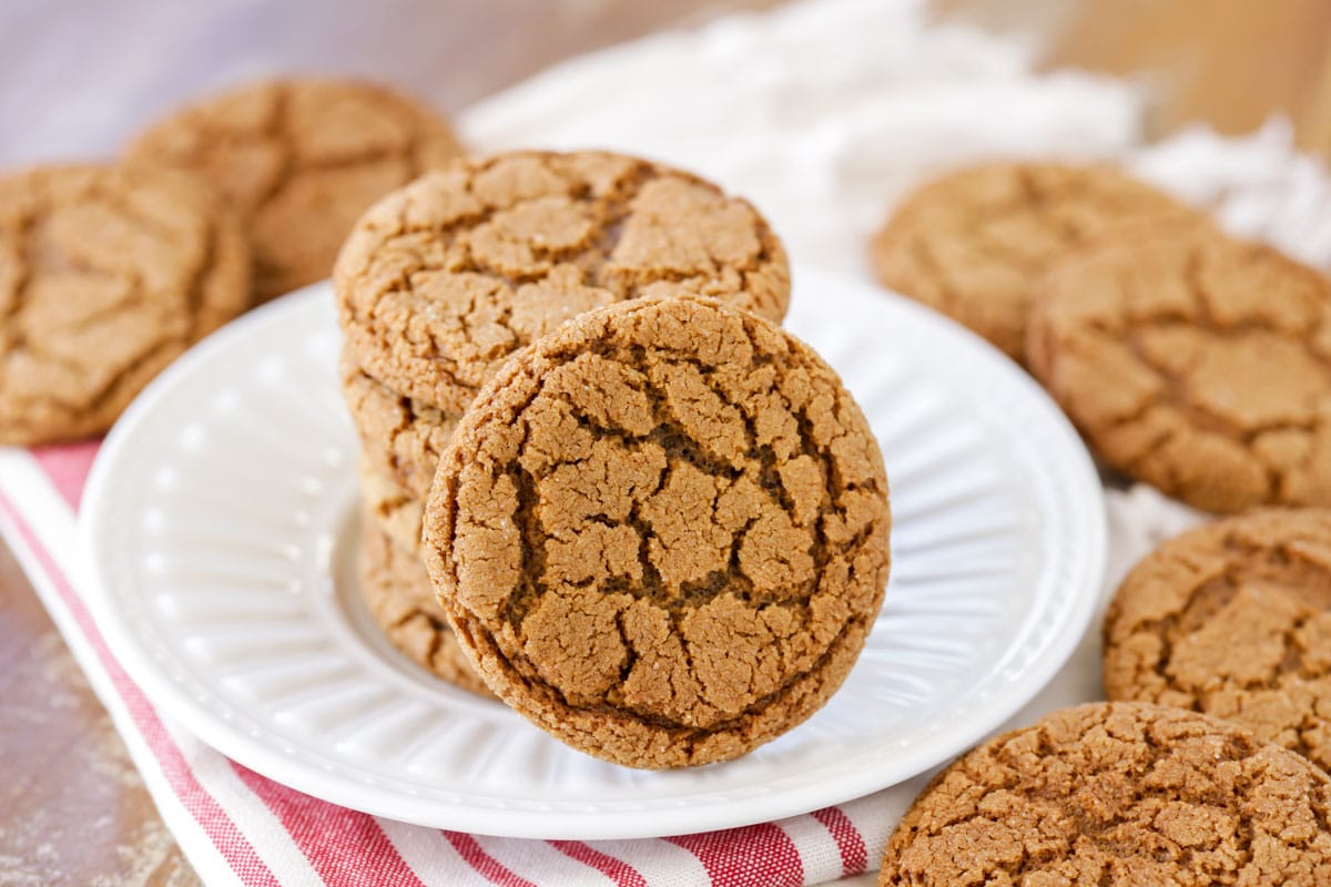 Stack of molasses cookies on a white plate