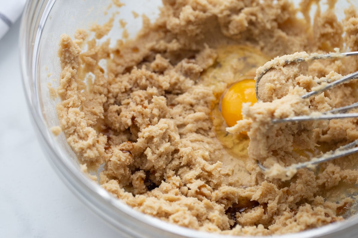Mixing dough ingredients together for oatmeal cookie recipe