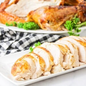 A sliced turkey seasoned in turkey brine.