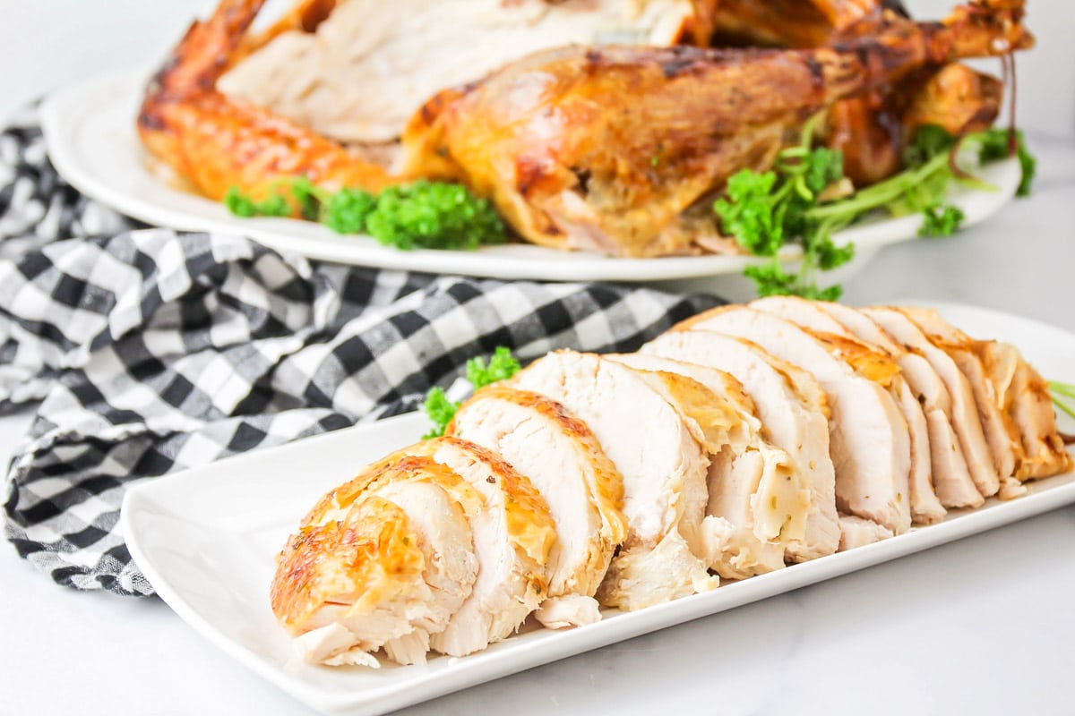 Sliced roast turkey breast on a white platter