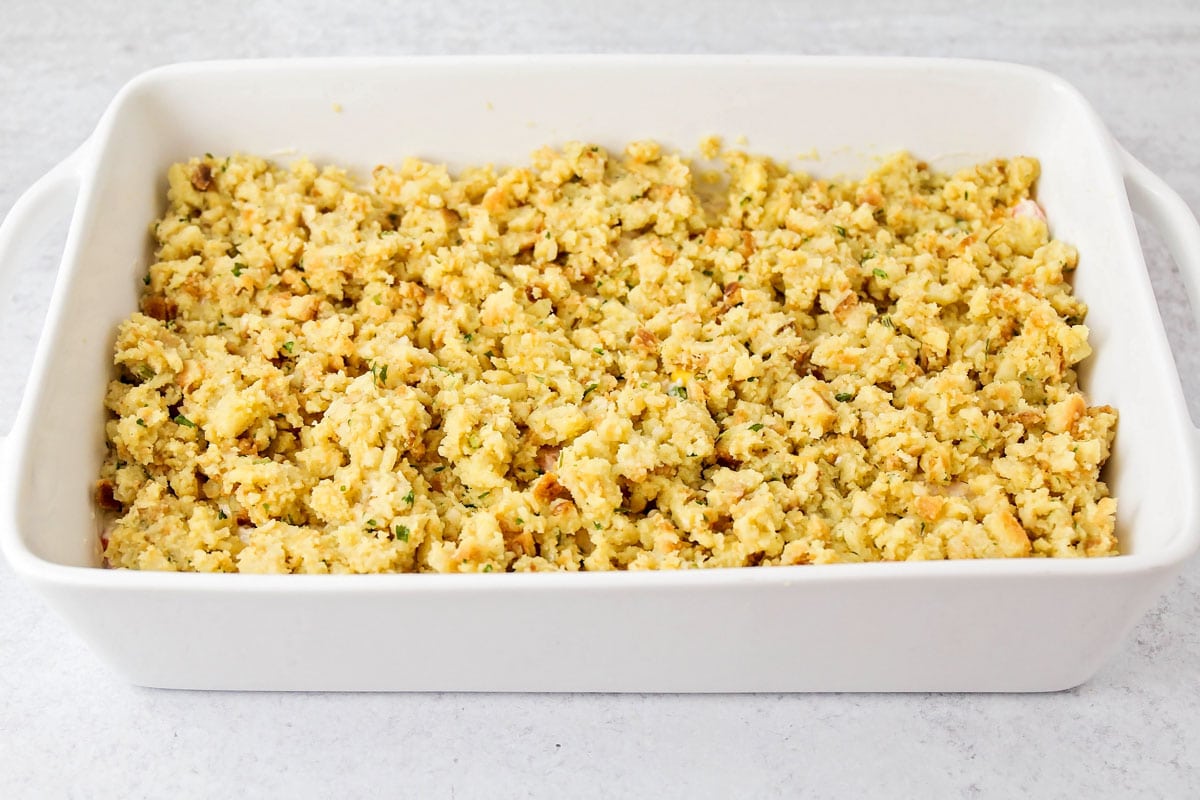 Layered chicken stuffing casserole served in a white baking dish