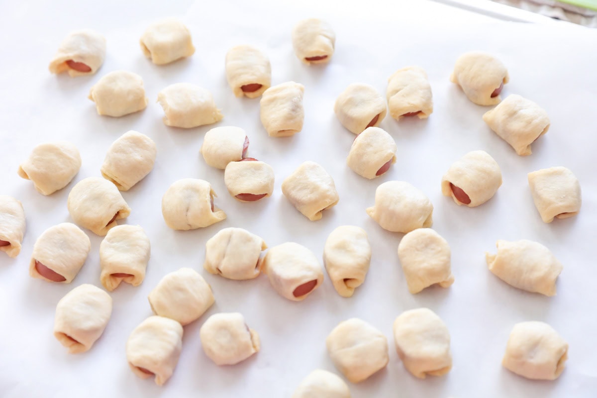 Our wildly popular mini hotdogs require only TWO ingredients and make a perfect lunch, dinner, or party appetizer! Mini hotdogs wrapped in dough and ready to bake.