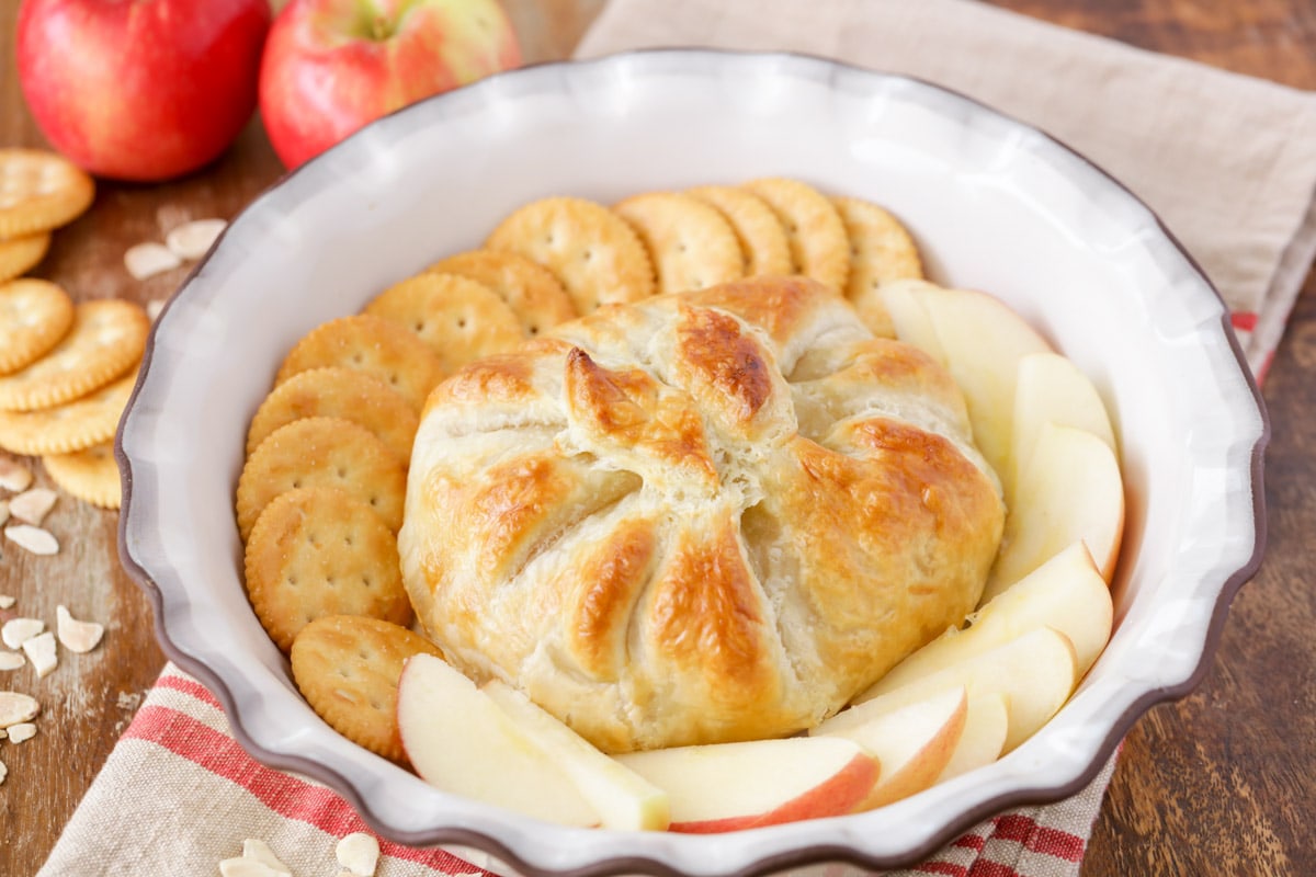 Thanksgiving appetizers - baked brie puff pastry served with crackers and apples.