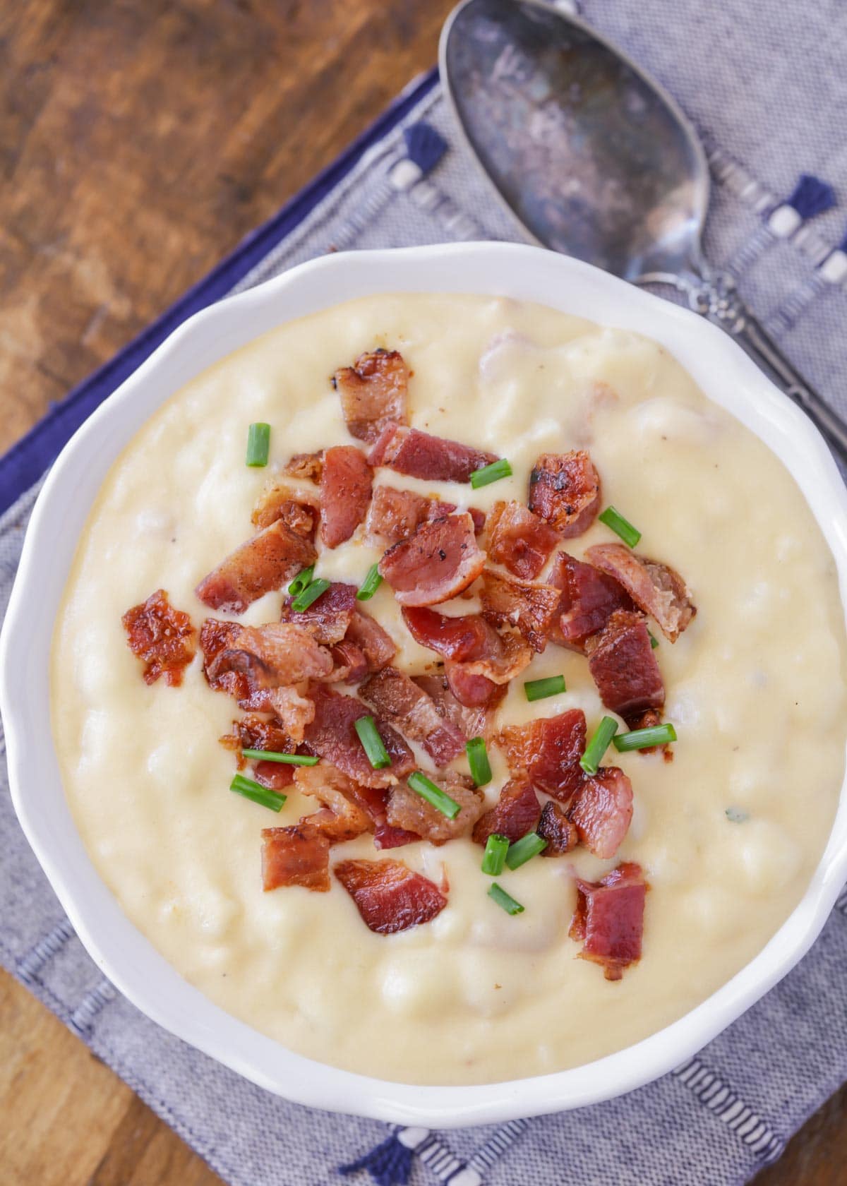 White bowl filled with potato and bacon soup