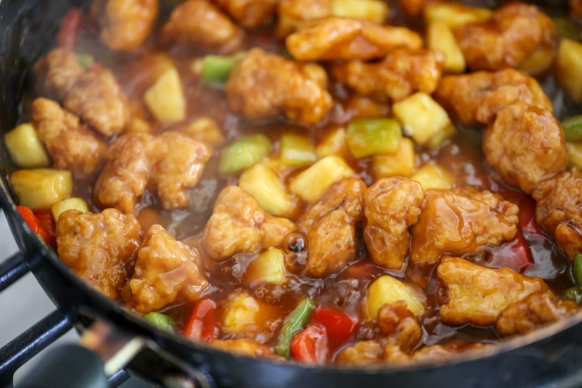 Pan full of sweet and sour sauce on chicken