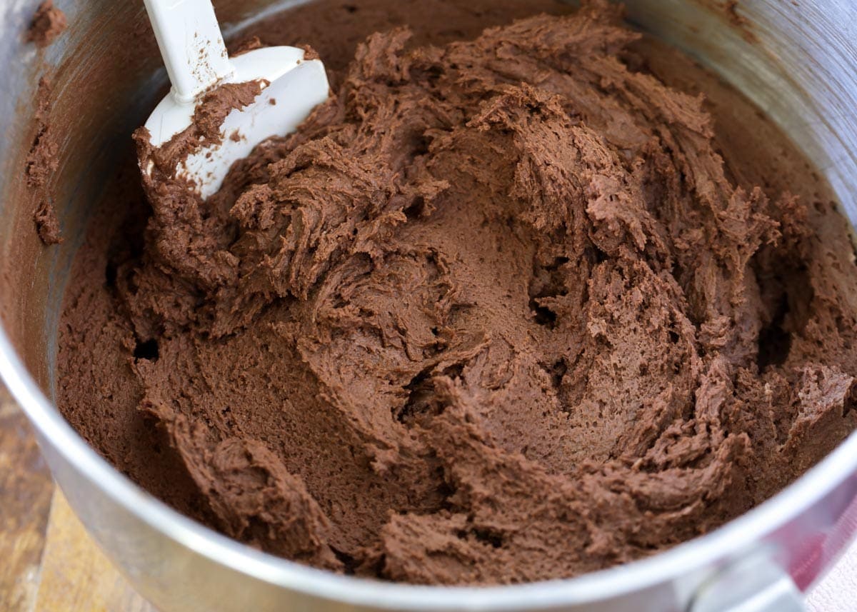 Chocolate cookie batter in a metal bowl.