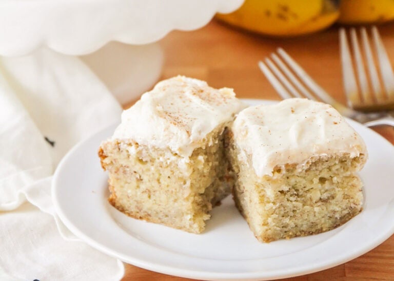 Banana bread brownies on white plate with forks.