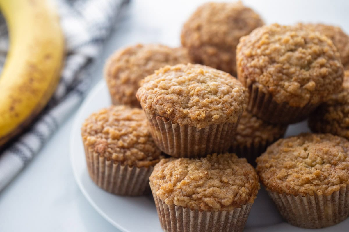 Close up of a plate filled with banana crumb muffins.