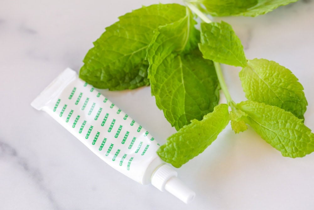 Fresh mint and green food coloring on a kitchen counter.