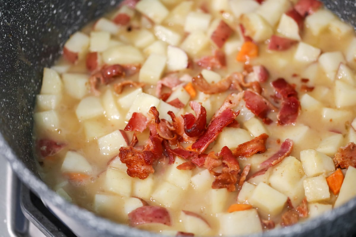 Simmering ingredients for baked potato soup.