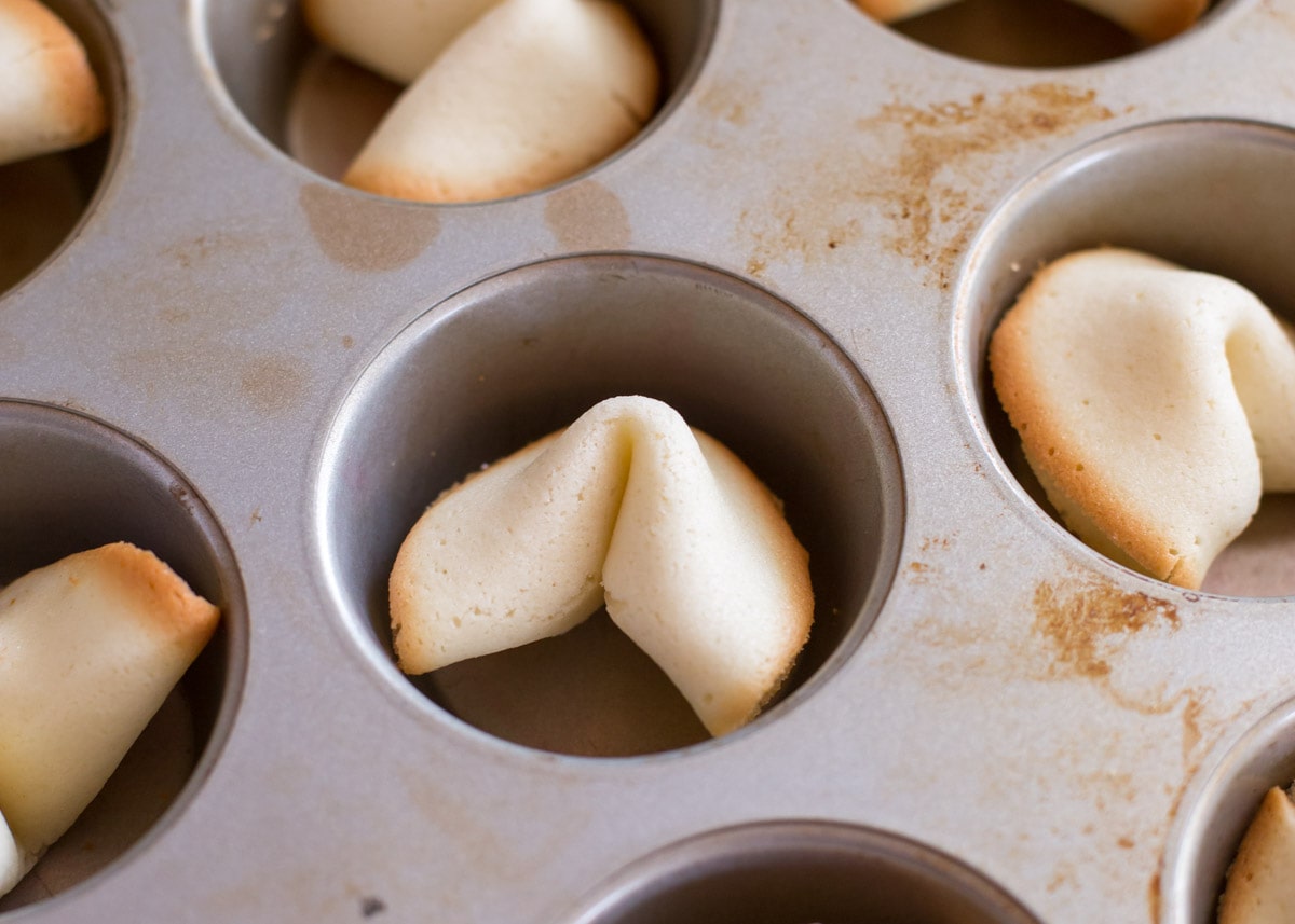 Homemade fortune cookies in a muffin tin