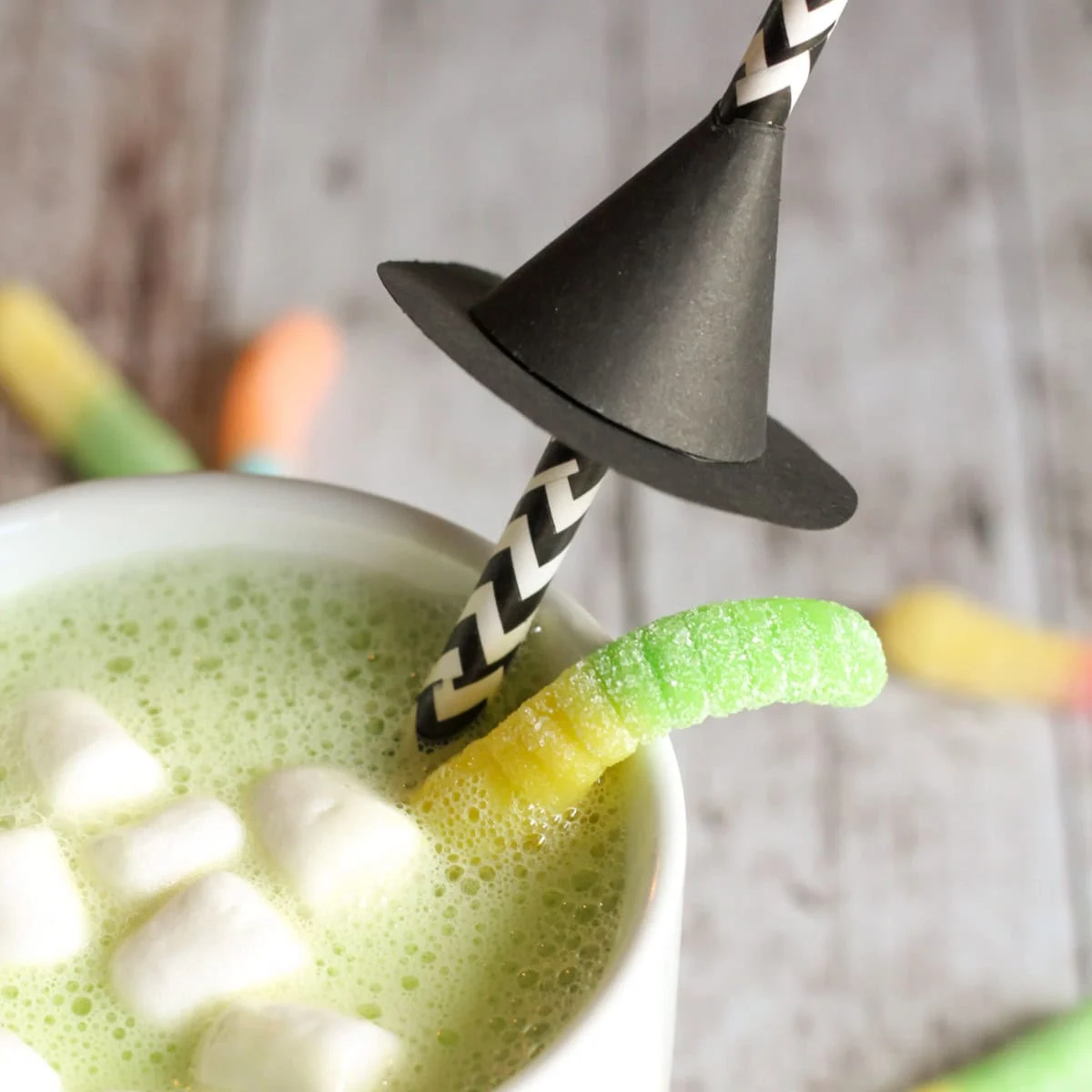 Close up of a witch hat on white chocolate Halloween Hot cocoa recipe.