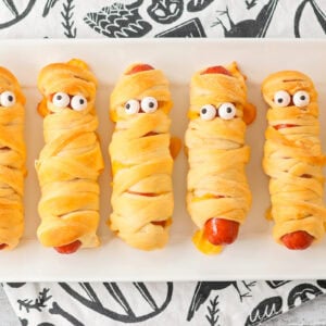Mummy hot dogs served on white platter.
