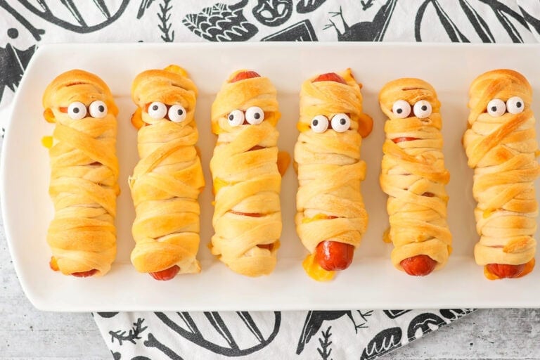 Mummy hot dogs served on white platter.