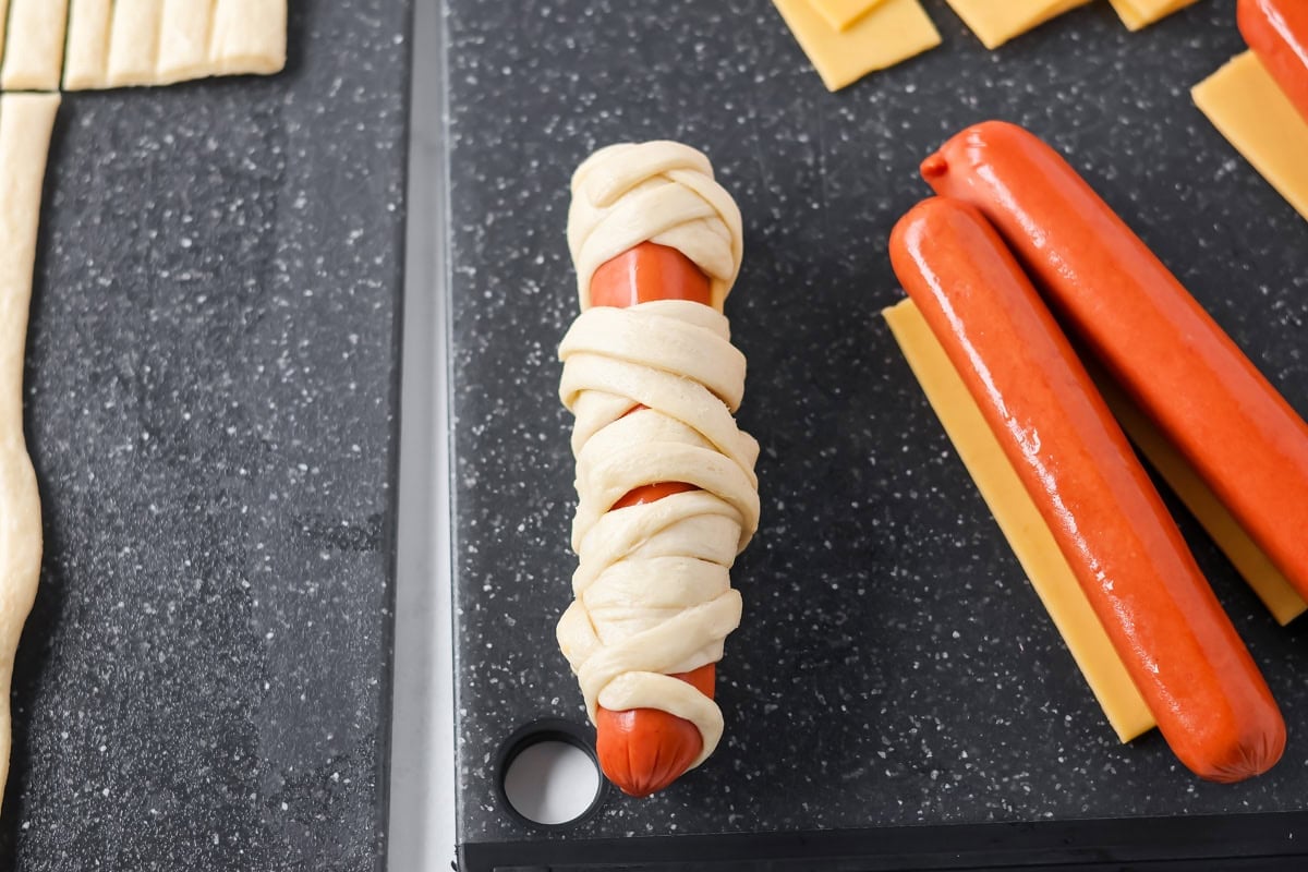 Mummy hot dogs wrapped in crescent dough strips.