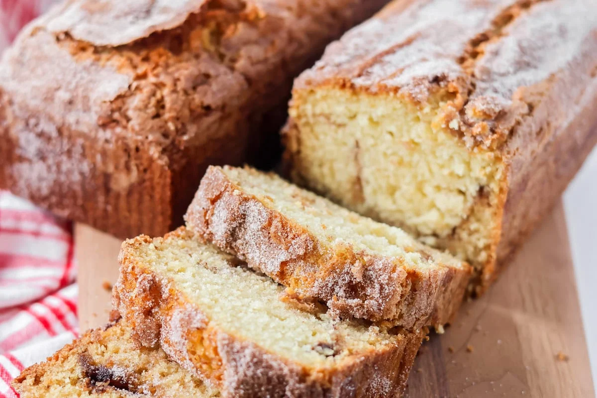 Amish friendship bread recipe cut into slices on cutting board.