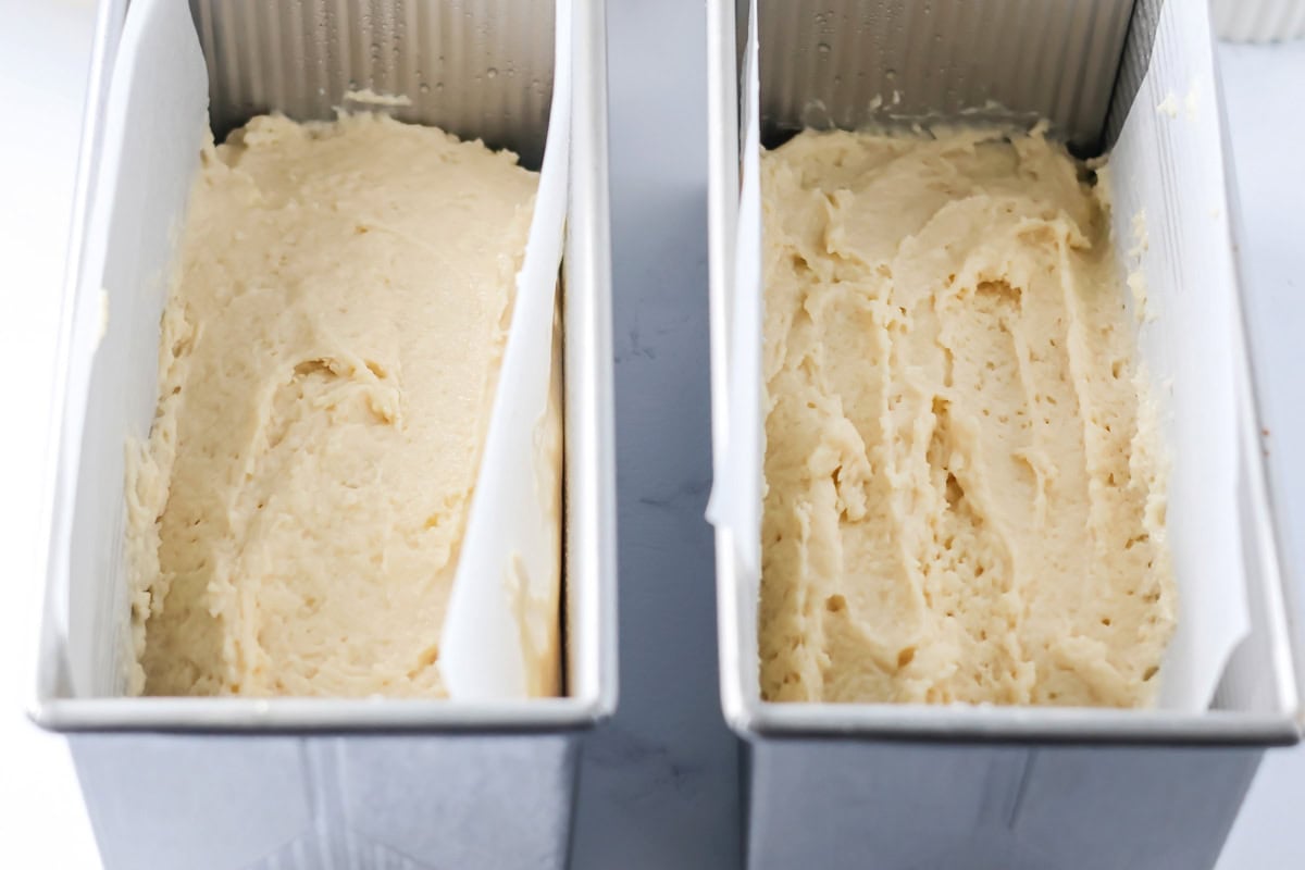 Bread batter half poured into bread pans.