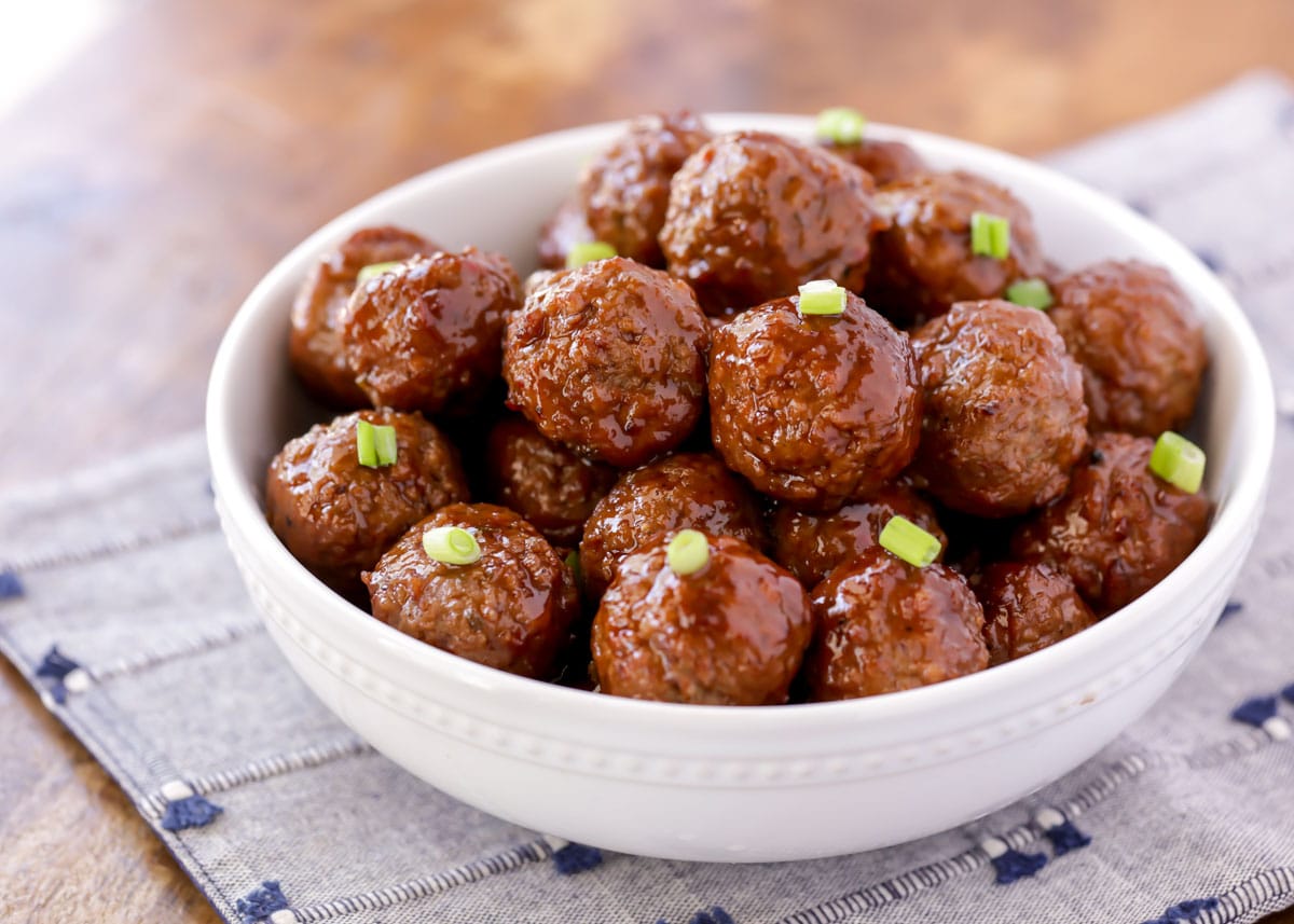 BBQ jelly meatballs served up in a white bowl.