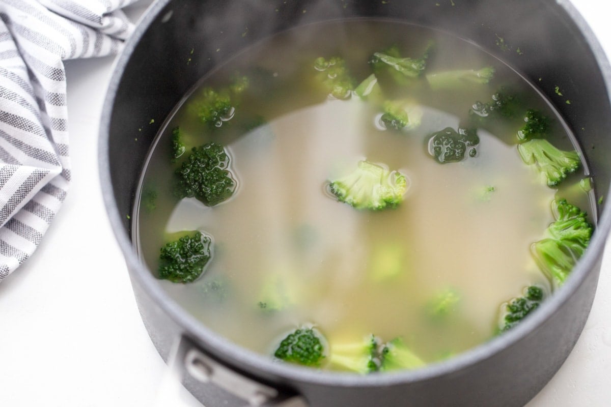 Broccoli boiling in pot of water.