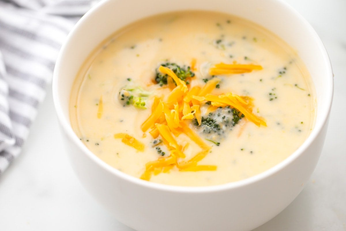 Broccoli cheese soup in white bowl